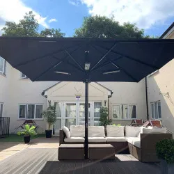 Sturdy and strong aluminium and stainless steel parasol with heating at a hotel outside area Outdoor living alfresco style by Aztec Umbrellas