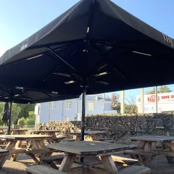 Sun and rain canopies ideal for pubs, bars and night clubs Parasol sun canopies shade solutions in bar beer garden in Cornwall