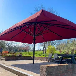 Centre Pole Parasols by Aztec Large Centre pole parasol on a large patio. Check out our parasol portfolio!