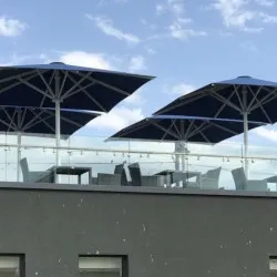 Exposed terrace showcasing UK made Aztec Umbrellas Terrace umbrellas for the hospitality industry